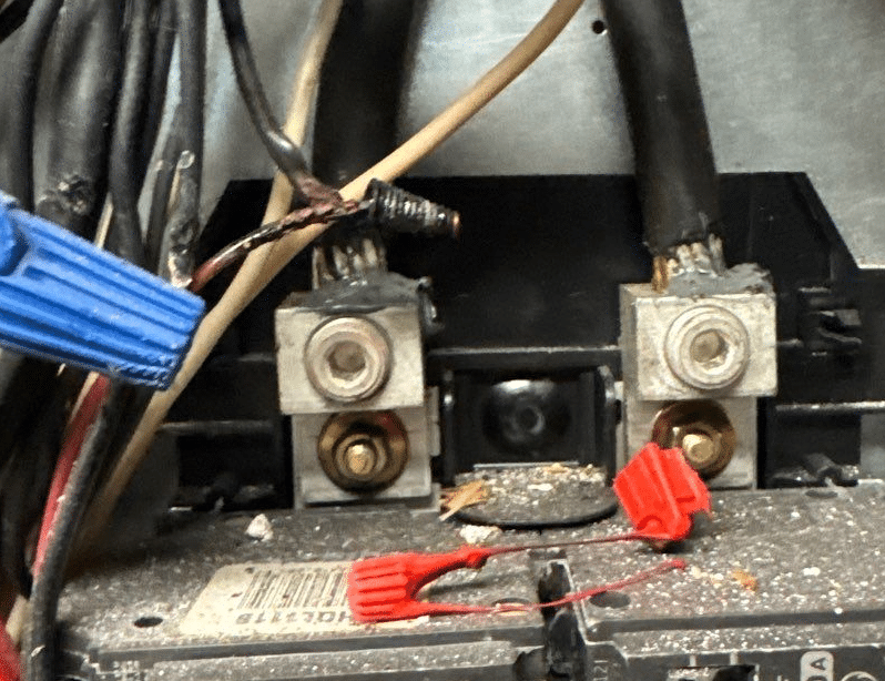 Close-up of wiring and wire connectors inside an electrical panel